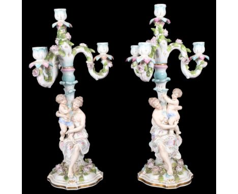 A pair of Vintage Continental porcelain candelabra on separate stands, supported by Classical figures with cherubs, H52cm 