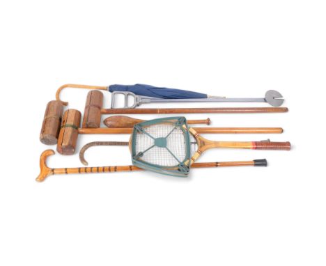 A group of various walking sticks, shooting stick, 2 croquet mallets, and a stick stand 