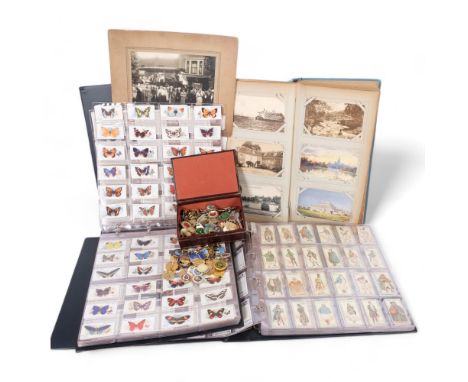 2 albums of cigarette cards, a Vintage postcard and photograph album, and a tin of Bowls badges 