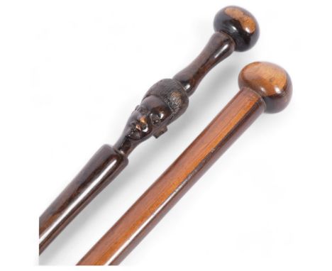 A Zulu lignum vitae ball end stick, length 93cm, and an African hardwood stick with carved head (2) 