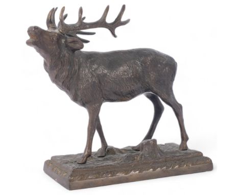 A cast-bronze study of a stag on naturalistic stand, H14cm, impressed mark to the underside 