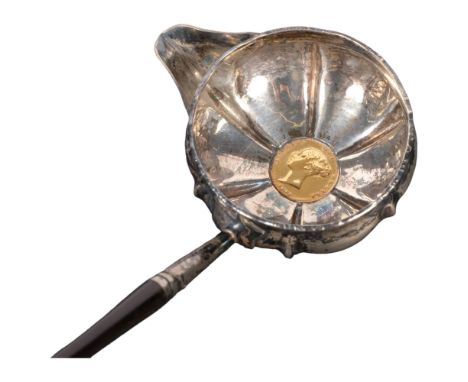 A Georgian silver toddy ladle with horn handle, the bowl inset with an 1842 half sovereign 