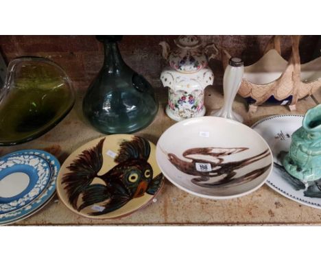 SHELF WITH MISC DECORATIVE GLASS & PLATES & A GLASS SHIP'S DECANTER STYLE BOTTLE MARKED CE 