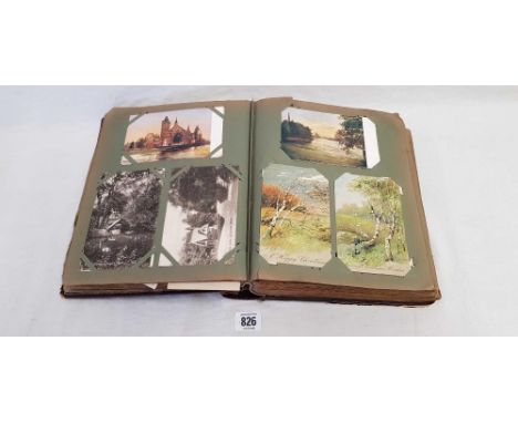AN OLD ALBUM OF VINTAGE POSTCARDS