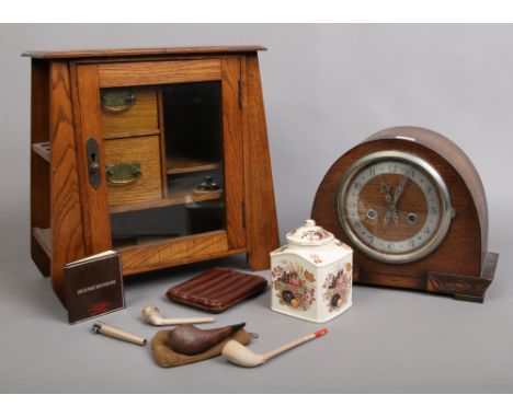 A carved oak smokers cabinet with contents of smoking items to include pipes, cigars etc along with a carved oak Enfield mant