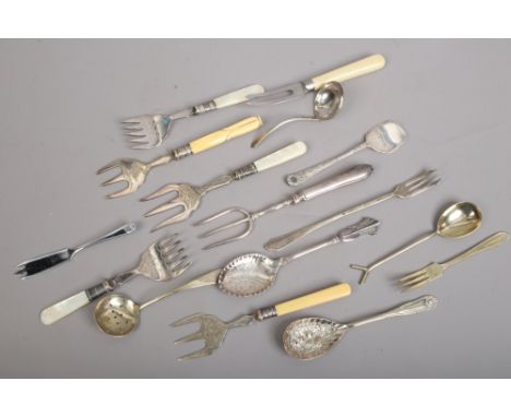 A collection of Victorian and later silver plated utensils including toasting fork etc.