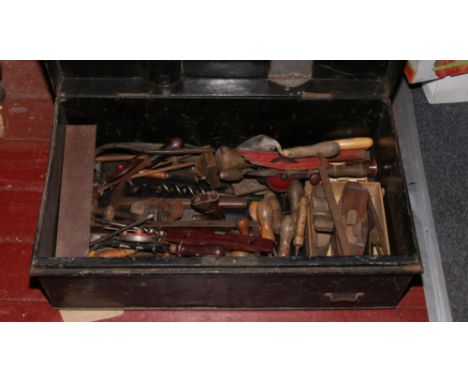 A metal trunk and contents of mostly wood working tools including planes, drills, sockets sets etc.