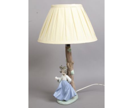 A Nao table lamp formed as a tree with a young girl holding a dove.