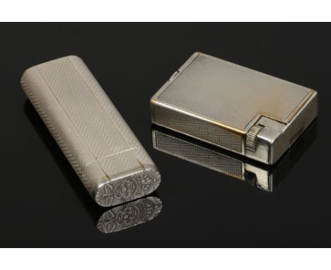 A silver plated Cartier lighter with engine turned engraving and a Dupont lighter.