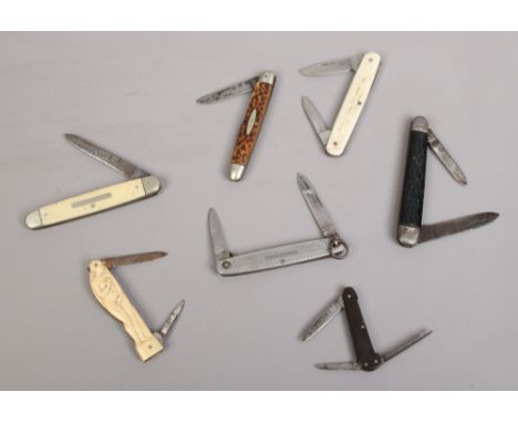 Seven folding pocket knives including stag antler scales and one decorated in relief with Venus.
