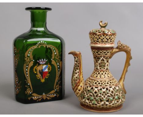 A 19th century Zsolnay Pecs reticulated ewer and cover in need of restoration, along with an armorial green glass decanter.Co