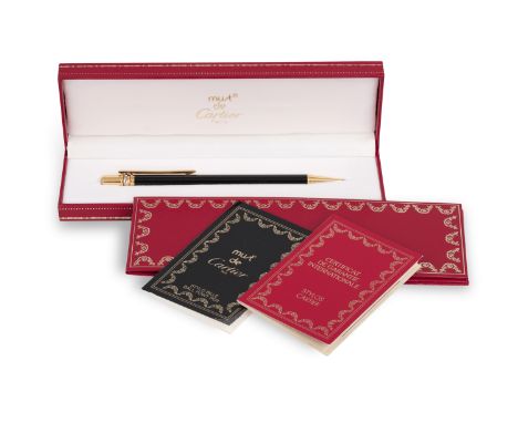 A BALL POINT PEN BY CARTIER, with rotary mechanism to eject ball point, refills, signed 'Must de Cartier, with maker's logo, 