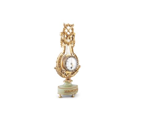 A FRENCH ONYX, ORMOLU AND DIAMONTE MOUNTED MANTLE CLOCK, 19th century, of lyre shape, surmounted with a floral garland, torch