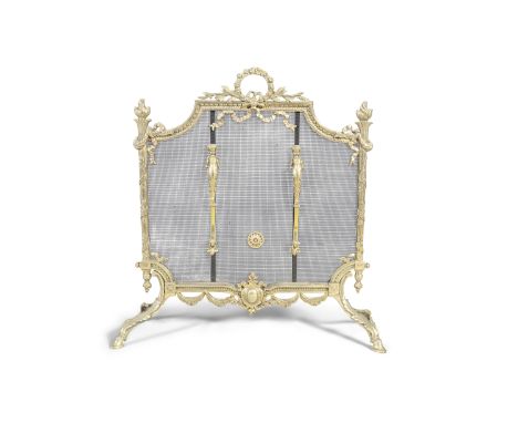 A FRENCH BRASS AND WIRE WORK FIRE SCREEN, of shaped rectangular form, fitted with ribbon tied wreath handle 