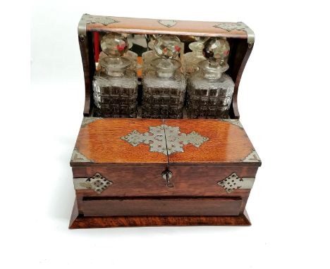 Antique oak tantalus (with key) &amp; 3 decanters &amp; sprung action drawer &amp; fold out lids with metal mounts - 34cm hig