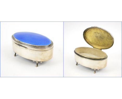 SILVER RING BOX, of oval form, the lid with blue guilloché enamel, four scroll feet, Birmingham 1929, 9.5cm L x 6cm W x 4.5cm
