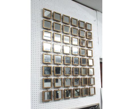 MIRROR WALL ART, with forty eight square mirrors in a gilded frame, 101cm x 75cm.