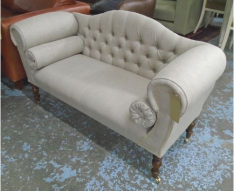 SOFA, two seater in neutral buttoned fabric on turned castor supports, 140cm L. 