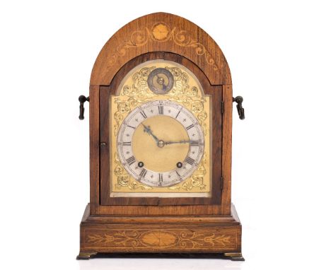 AN EDWARDIAN ROSEWOOD AND INLAID BRACKET CLOCK, with arched top, the gilt dial with foliate spandrels and silvered chapter ri