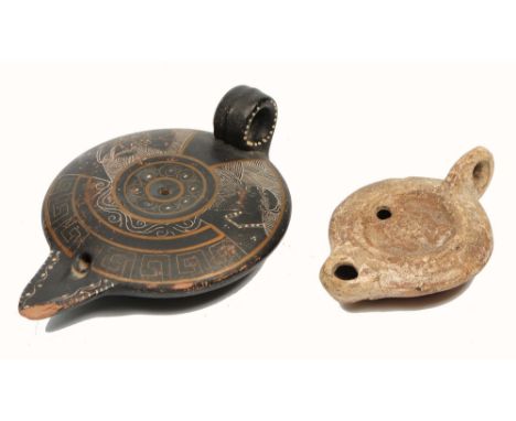 A ROMAN POTTERY OIL LAMP, 11.5cm long, and black glazed and incised Greek revival pottery oil lamp (2)