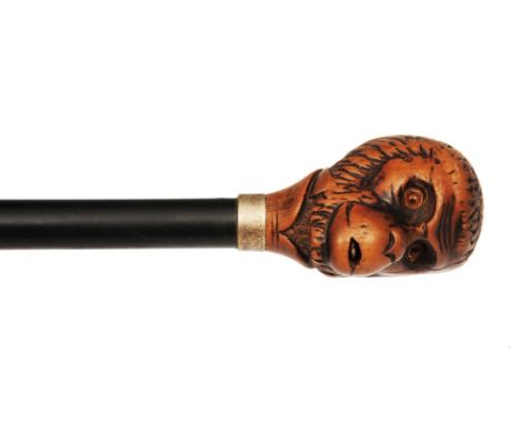 A LATE 19TH/EARLY 20TH CENTURY NOVELTY CANE, the wooden handle carved as a monkey's head, with push-button mechanical protrud