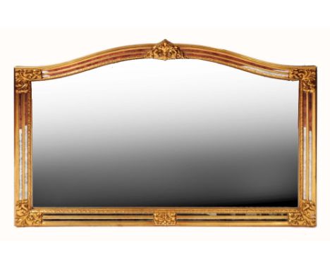 A GILT FRAME MANTEL MIRROR with fluted and floral decoration and shaped top, approximately 180 x 130cm