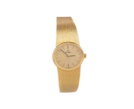 LADY'S OMEGA EIGHTEEN CARAT GOLD MANUAL WIND WRIST WATCH,the oval textured champagne dial with baton hour markers, 22mm case,