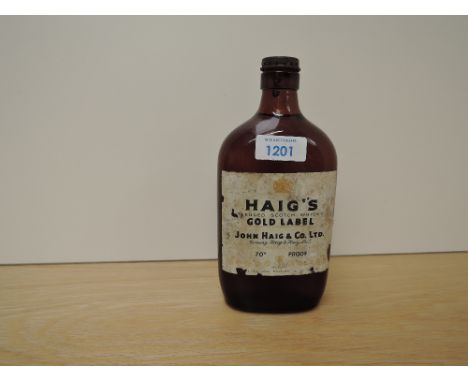 A flat bottle of Haig's Gold Label Blended Scotch Whisky, 70% proof, no capacity stated, spring cap fastening, label missing 
