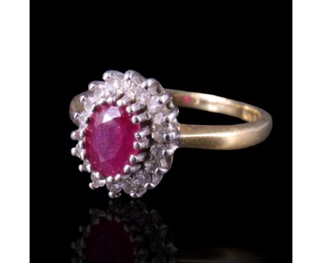 A ruby and diamond cluster ring comprising a central oval-cut stone of approx 1 ct, claw-set between a petal-like arrangement