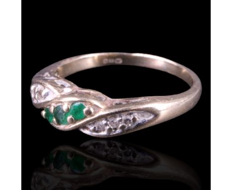 An emerald and diamond crossover ring comprising alternate trios of round-cut stones, pellet-set on 9 ct gold, N, 2.5 g 