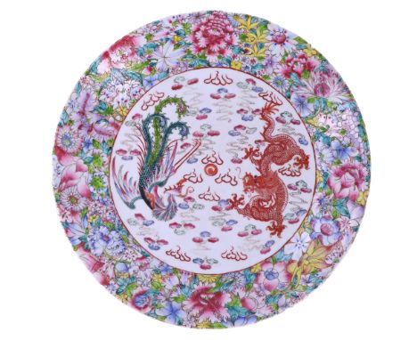 A Chinese large Famille Rose porcelain dragon-and-phoenix dish, decorated in depiction of the mythical beasts chasing a flami