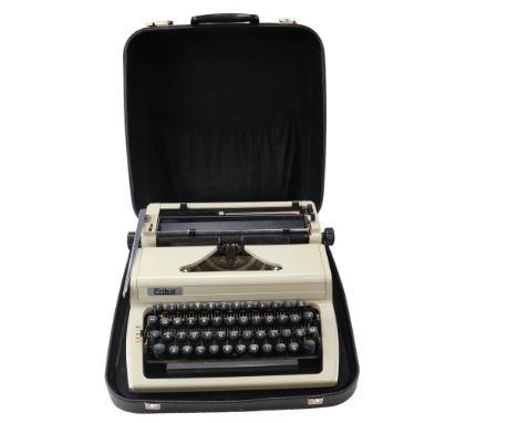 A cased Erika 105 portable typewriter, instruction manual and accessories, circa 1970s, case 37 x 40 x 16 cm 