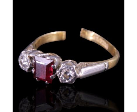 A ruby and diamond dress ring comprising a central princess-cut ruby of approx 0.4 cts, cathedral-set between two round-cut d