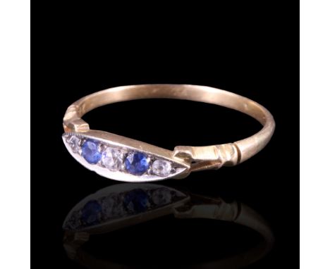 An early 20th Century diamond and blue stone ring, the five small graded stones set within a slender navette between the bifu