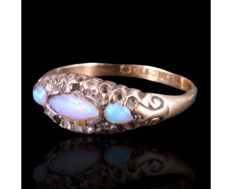A Victorian opal and diamond dress ring comprising a central oval opal cabochon surrounded by a row of small rose-cut diamond