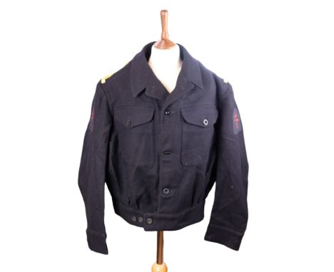 A 1944 Royal Navy officer's Working Dress blouse bearing rank epaulettes and printed Combined Operations formation signs