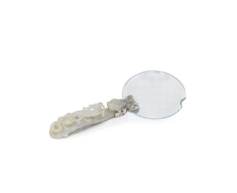 A PALE GREEN JADE BELT HOOK MOUNTED AS MAGNIFYING GLASS19th centuryThe jade buckle carved and pierced with a dragon head hook