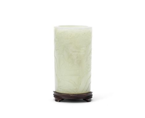 A CARVED PALE GREEN JADE BRUSHPOT18th/19th centuryOf cylindrical form, the exterior carved to depict a continuous rocky lands