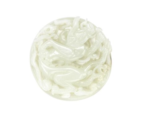 A RETICULATED WHITE JADE CIRCULAR 'DRAGON' PLAQUEMing DynastyCarved with a sinuous dragon with long mane coiled dramatically 