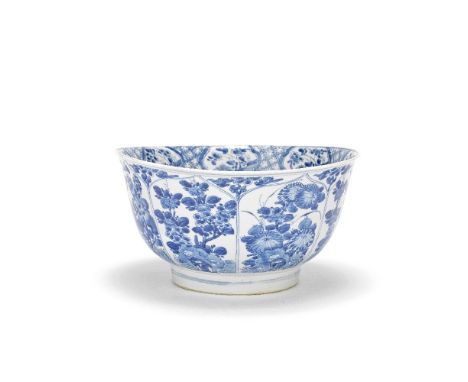 A LARGE BLUE AND WHITE BOWLKangxiPainted to the exterior with petal shaped panels of flowering plants issuing from pierced ro