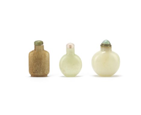 THREE JADE SNUFF BOTTLES19th centuryComprising: a white jade bottle; a pale celadon bottle; and a russet jade bottle.The tall