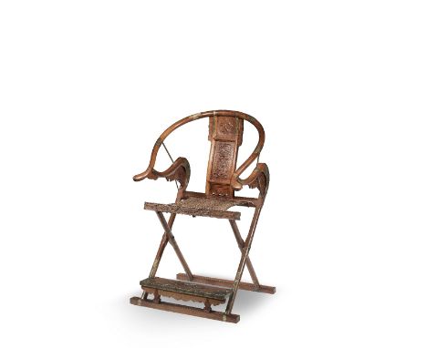A HUANGHUALI FOLDING CHAIR20th centuryWith horseshoe shaped top rail descending to outward sweeping arm rests, the gently cur