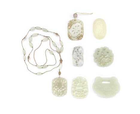 A GROUP OF SEVEN JADE PLAQUES19th/20th centuryComprising: a lock-form pendant incised on one side with a bouquet of lotus flo