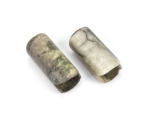 TWO ARCHAISTIC JADE WRIST CUFFS19th/20th centuryEach of well-hollowed cylindrical form, incised to depict a tiger with open m