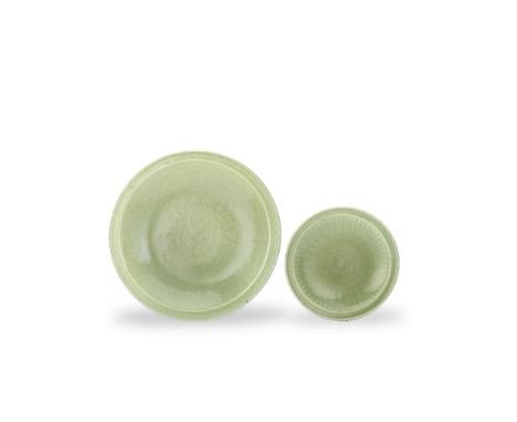 TWO LONGQUAN CELADON GLAZED CHARGERSMing DynastyThe first carved with a large central spray of lotus flowers within meanderin