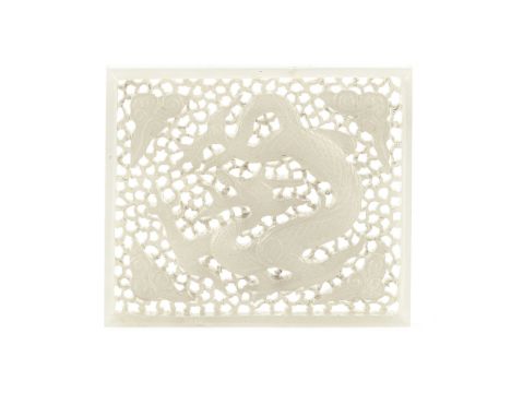 A CARVED AND PIERCED WHITE JADE 'DRAGON' PLAQUEMing DynastyOf rectangular form, carved with a coiled dragon framed by four cl