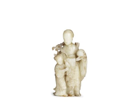 A MUTTON FAT JADE FIGURE OF A FEMALE IMMORTAL AND ATTENDANT18th/19th centuryThe Immortal holding a peach in her hands, with h