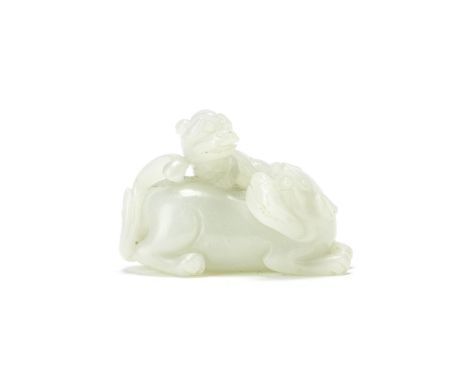 A WHITE JADE 'LIONS' GROUP19th centuryThe larger animal seated with the head turned upwards to the right, with a cub clamberi