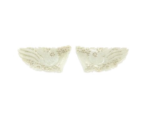 A PAIR OF JADE 'PHOENIX' PLAQUES19th centuryEach carved and pierced in mirror image with wings spread, and the head turned ba