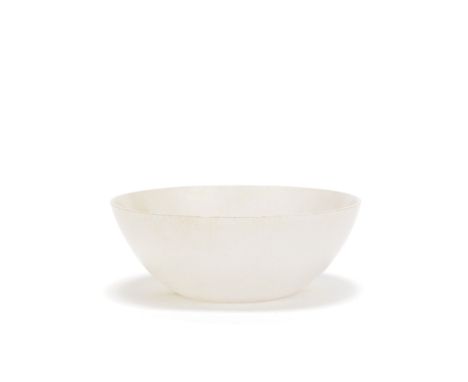 A WHITE JADE BOWL19th centuryCarved with shallow rounded sides and concave foot, the translucent stone with mottled cloudy in